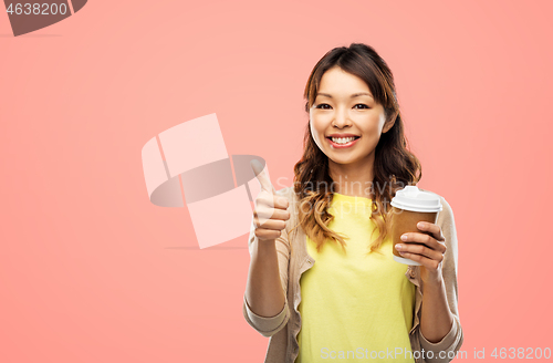 Image of asian woman drinking coffee and showing thumbs up