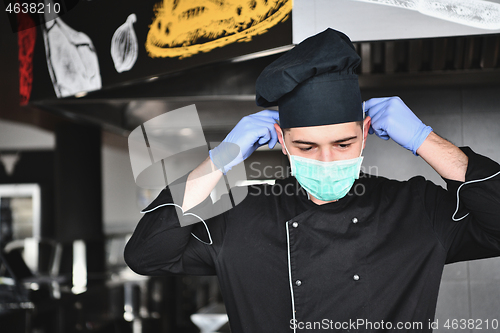 Image of chef cook wearing face protective medical mask for protection fr