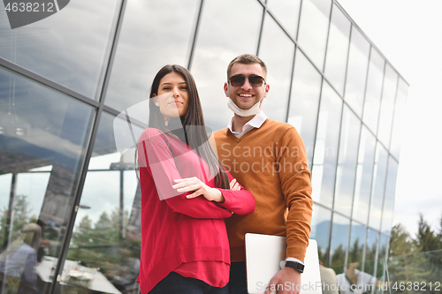 Image of business people wearing protective mask