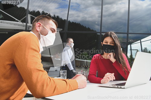 Image of business people wearing protective mask