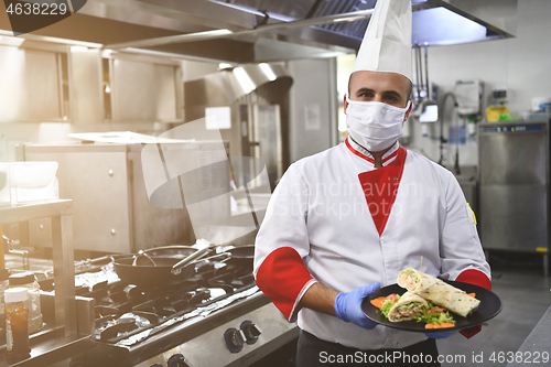 Image of chef cook wearing face protective medical mask for protection fr