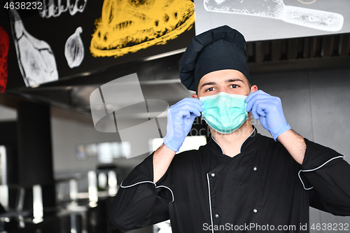 Image of chef cook wearing face protective medical mask for protection fr