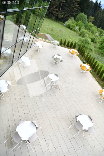 Image of restaurant tables and chairs at outdoor sitting at restaurant  d