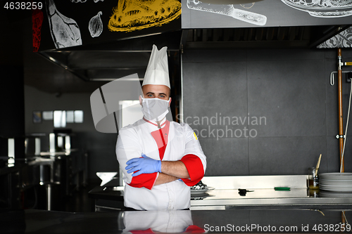 Image of chef cook wearing face protective medical mask for protection fr