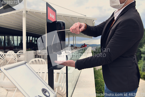 Image of hands disinfection in restaurant