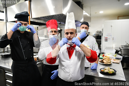 Image of group chefs standing together in the kitchen at restaurant weari