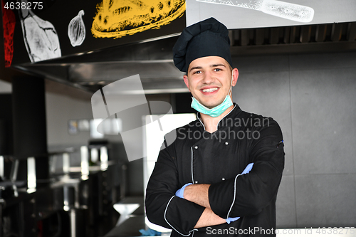 Image of chef cook wearing face protective medical mask for protection fr