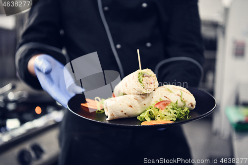 Image of chef cook wearing face protective medical mask for protection fr