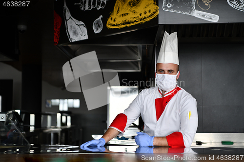 Image of chef cook wearing face protective medical mask for protection fr