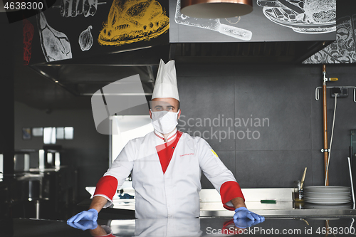 Image of chef cook wearing face protective medical mask for protection fr