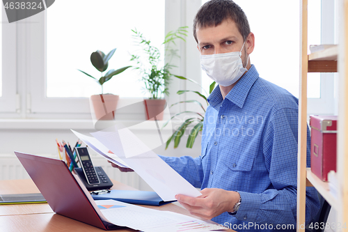 Image of a person in an office in the workplace is studying the data in the documents