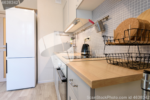 Image of View along the countertop on a fragment of the interior of a modern kitchen