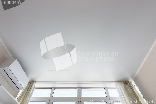 Image of Fragment of the suspended ceiling above the window in the room, next to air conditioning