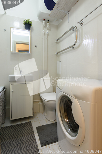 Image of Classic small toilet with washing machine and washbasin