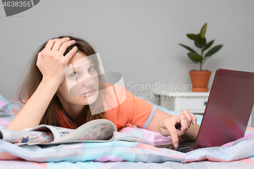 Image of A girl cannot find work either on the Internet or in newspaper ads