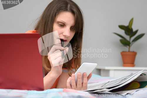 Image of Girl thought looking at the screen of a mobile phone while looking for work