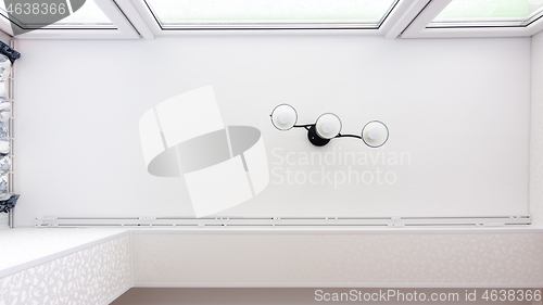 Image of Stretch ceiling with a chandelier in a glazed attic