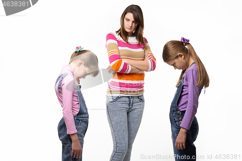 Image of The girls are ashamed in front of their mother, their mother scolds them