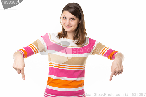 Image of Girl with a charming smile points fingers down