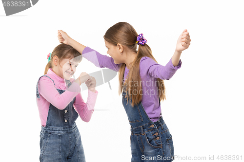 Image of A girl beats another girl on the head