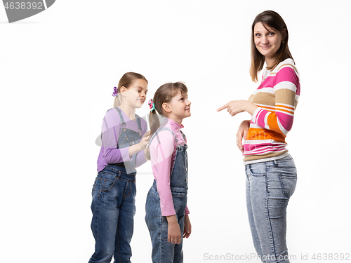 Image of The girl begs the toy from her mother, mother wearily points a finger at the child