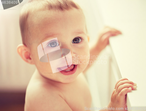 Image of happy little baby boy or girl at home