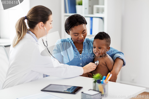 Image of doctor with stethoscope listening baby at clinic