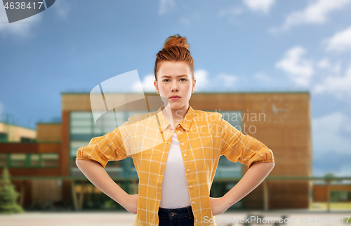 Image of serious red haired teenage girl with hands on hips