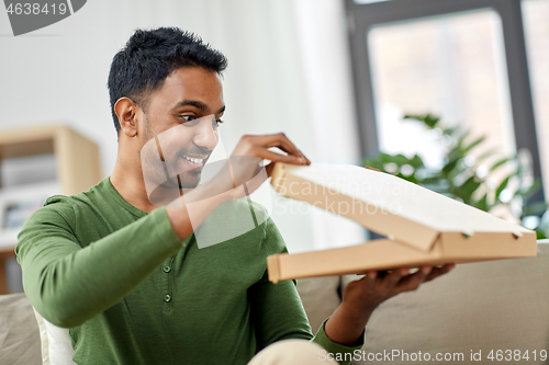 Image of indian man looking inside of takeaway pizza box