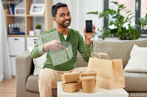 Image of indian man using smartphone for food delivery