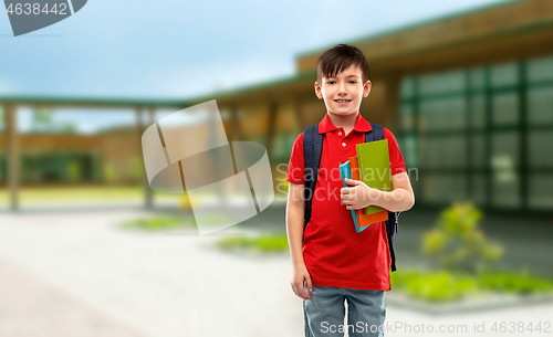 Image of smiling student boy with books and school bag