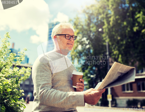 Image of senior man reading newspaper and drinking coffee