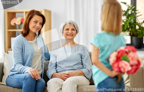 Image of grandmother, mother and daughter with flowers