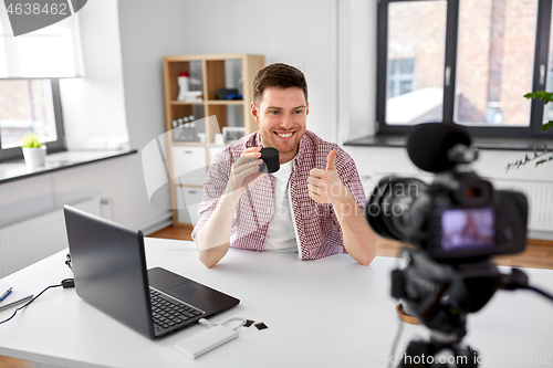 Image of video blogger with smart speaker shows thumbs up