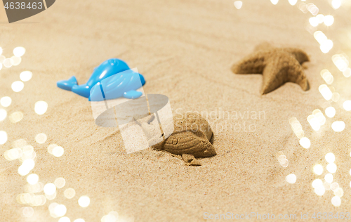 Image of sand shape made by whale mold on summer beach