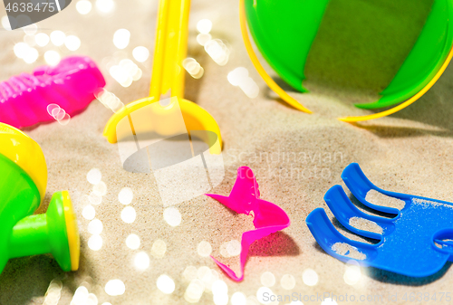 Image of close up of sand toys kit on summer beach