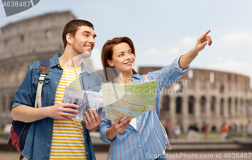 Image of happy couple of tourists with city guide and map