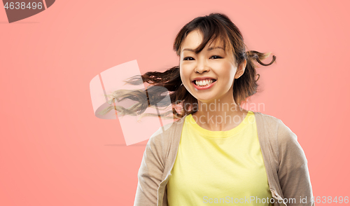 Image of happy asian woman with waving hair