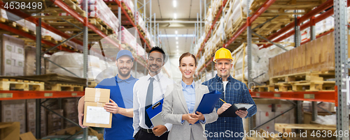 Image of group of business people and warehouse workers