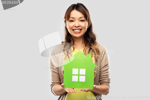 Image of happy asian woman with green house