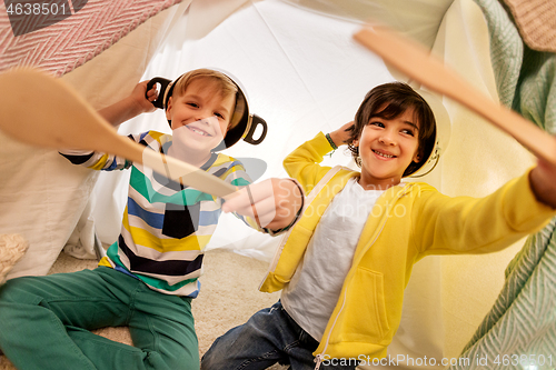 Image of boys with pots playing in kids tent at home