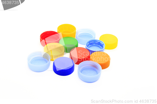 Image of Multicolored caps from plastic bottles on white background