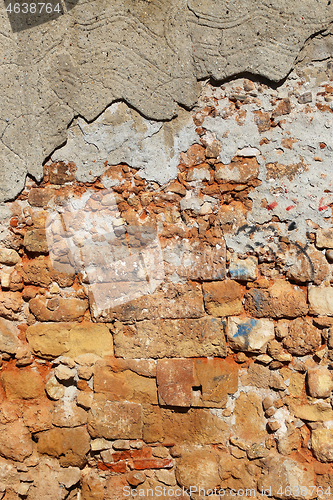 Image of Very ancient destroyed brick wall with concrete