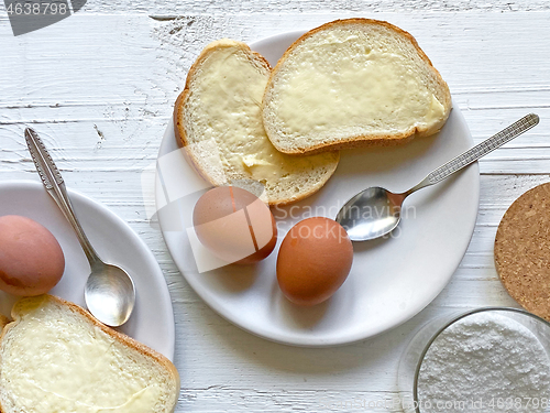 Image of boiled eggs and bread with butter