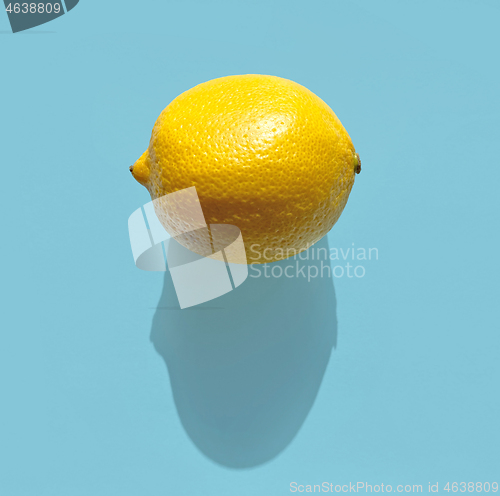 Image of fresh lemon with long shadow