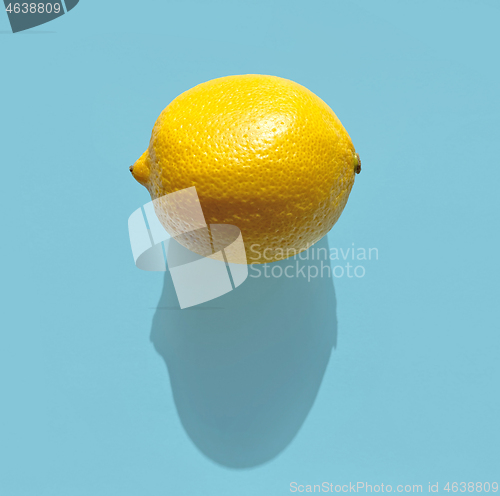 Image of fresh lemon with long shadow