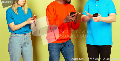 Image of Group of friends using mobile smartphones. Teenagers addiction to new technology trends. Close up.