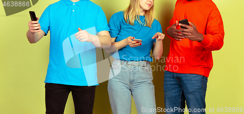 Image of Group of friends using mobile smartphones. Teenagers addiction to new technology trends. Close up.