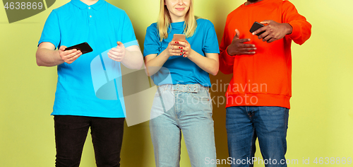 Image of Group of friends using mobile smartphones. Teenagers addiction to new technology trends. Close up.