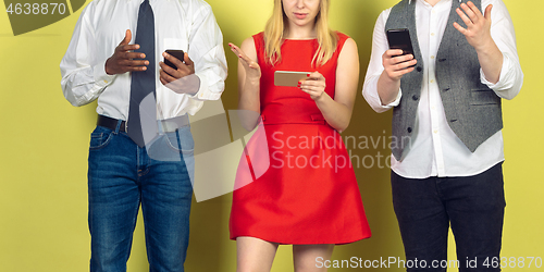 Image of Group of friends using mobile smartphones. Teenagers addiction to new technology trends. Close up.